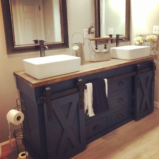 Custom navy barn-door double vanity with vessel sinks and framed mirrors